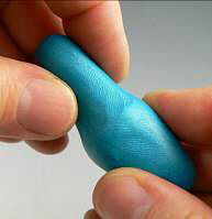 Blue clay being shaped